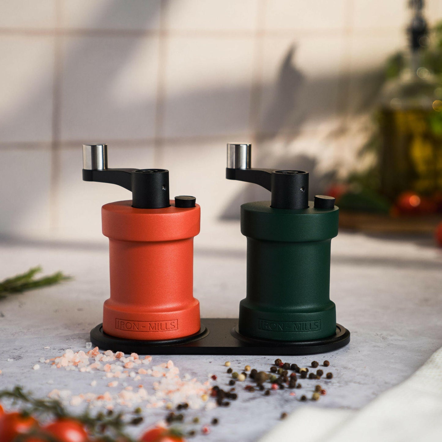 Iron-Mills coral red and ivy green salt and pepper mills on a handcrafted mill base, ideal for adding elegance to any meal